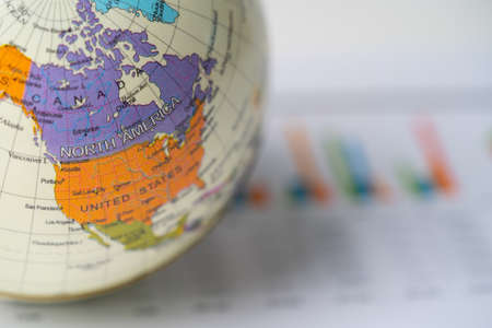 BANGKOK,THAILAND.JULY 1,2020 America map at globe on graph paper background, banking account,...