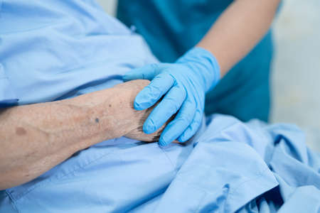 Doctor wearing medical mask and gloves with stethoscope in hospital for protect infection and kill...