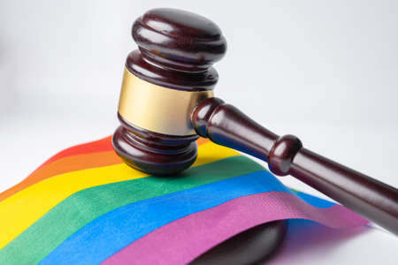 Gavel for judge lawyer on rainbow flag, symbol of LGBT pride month celebrate annual in June social of gay, lesbian, bisexual, transgender, human rights.の写真素材
