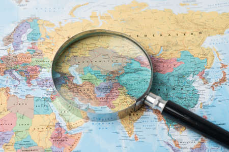 Bangkok, Thailand - August 01, 2020 Europe, Magnifying glass close up with colorful world map, Magnifying glass close up with colorful world mapのeditorial素材