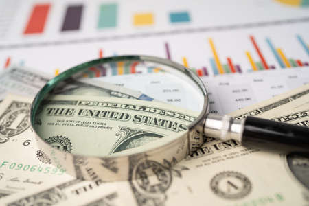 Magnifying glass and US dollar banknotes background, Banking Account, Investment Analytic research data economy, trading, Business company concept.の写真素材