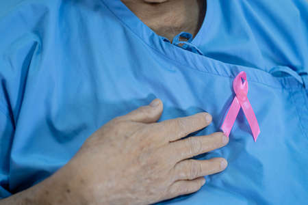 Breast cancer, pink ribbon at Asian senior lady patient for supporting awareness.の写真素材