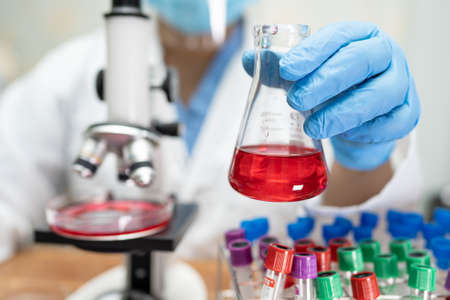 Scientist holding and analysis tube of micro biological sample outbreak Coronavirus or Covid-19...