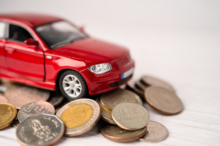 Car on coins background; Car loan, Finance, saving money, insurance and leasing time concepts.の写真素材