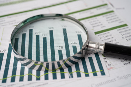 Magnifying glass on charts graphs paper. Financial development, Banking Account, Statistics, Investment Analytic research data economy, Stock exchange trading, Business office company meeting concept.の写真素材