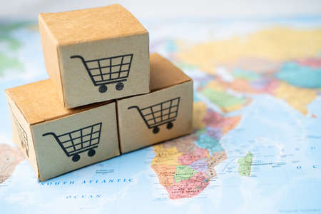 Shopping cart logo on box on world globe map background. Banking Account, Investment Analytic research data economy, trading, Business import export transportation online company concept.の写真素材