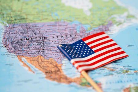 Bangkok, Thailand - February 7, 2021; USA United of America flag on world map background.のeditorial素材