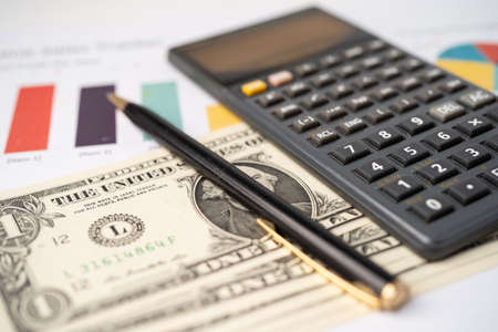 Pen and calculator on chart or graph paper. Financial, account, statistics and business data...