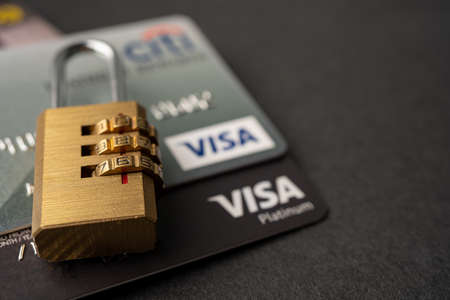 Bangkok, Thailand - July 1, 2020 Golden security digital password lock key on visa master card background.のeditorial素材