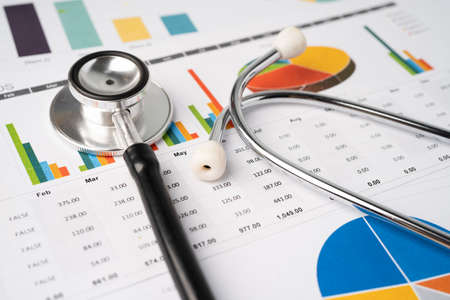 Stethoscope on chart graph paper, finance, account, statistic, analytic economy Business concept.の写真素材