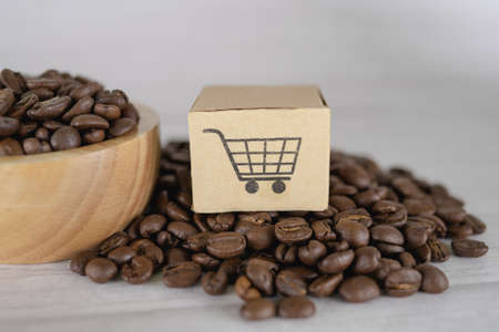 Box with shopping cart logo symbol on coffee beans, Import Export Shopping online or eCommerce delivery service store product shipping, trade, supplier concept.の写真素材