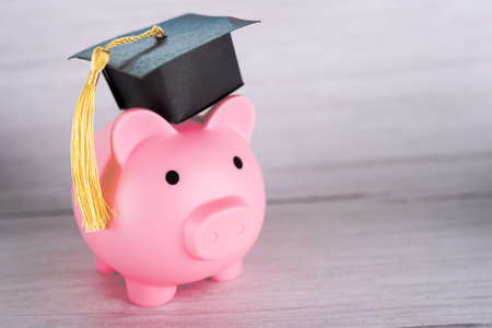 Piggy bank with graduation cap, Business finance education saving money scholarship concept.の写真素材