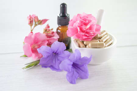 Alternative medicine herbal organic capsule with vitamin E omega 3 fish oil, mineral, drug with herbs leaf natural supplements for healthy good life.の写真素材