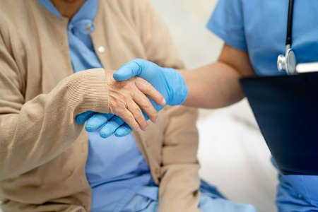 Asian doctor wearing PPE suit new normal to check patient protect safety infection  outbreak at...