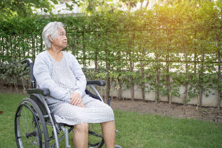 Asian senior or elderly old lady woman patient on wheelchair in park, healthy strong medical...