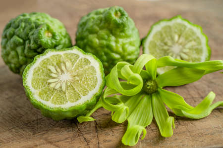 Fresh bergamot fruit with cut in half on wooden background.の写真素材