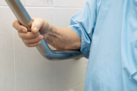 Asian senior or elderly old lady woman patient use toilet bathroom handle security in nursing...