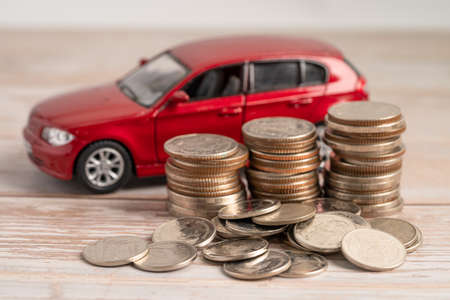 Car on coins background; Car loan, Finance, saving money, insurance and leasing time concepts.の写真素材