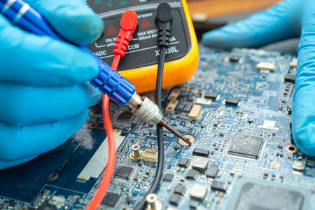 technician repairing inside of hard disk by soldering iron. Integrated Circuit. the concept of data, hardware, technician and technology.の写真素材