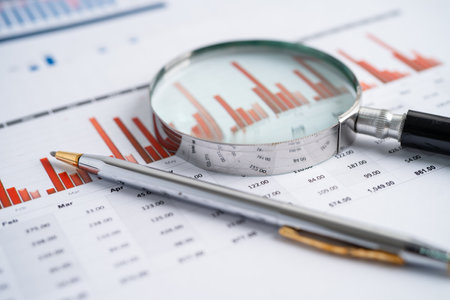 Magnifying glass on charts graphs paper. Financial development, Banking Account, Statistics, Investment Analytic research data economy, Stock exchange trading, Business office company meeting concept.の写真素材
