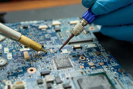 Repairing inside of hard disk by soldering iron. Integrated Circuit. the concept of data, hardware,...