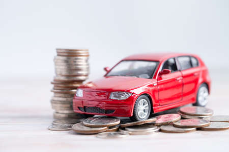 Car on stack of coins. Car loan, Finance, saving money, insurance and leasing time concepts.の写真素材