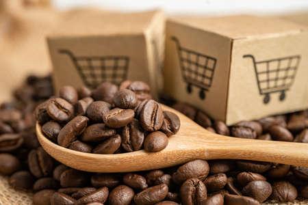 Box with shopping cart logo symbol on coffee beans, Import Export Shopping online or eCommerce delivery service store product shipping, trade, supplier concept.の写真素材