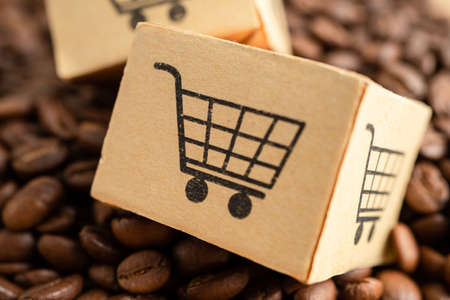 Box with shopping cart logo symbol on coffee beans, Import Export Shopping online or eCommerce delivery service store product shipping, trade, supplier concept.の写真素材