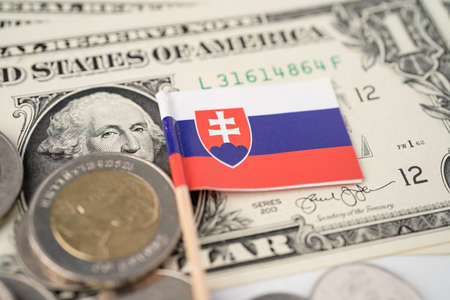 Stack of coins with Slovakia flag on USA America dollar banknotes.の写真素材