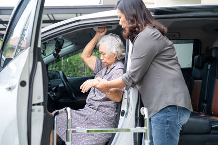 Help and support asian senior or elderly old lady woman patient walk with walker prepare get to her...