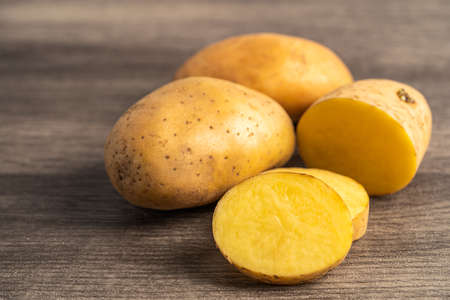 Potato raw and fresh vegetable food on wooden background.の写真素材