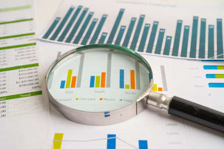 Magnifying glass on charts graphs paper. Financial development, Banking Account, Statistics, Investment Analytic research data economy, Stock exchange trading, Business office company meeting concept.の写真素材