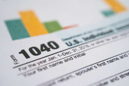 Tax Return form 1040 and dollar banknote, U.S. Individual Income.の写真素材