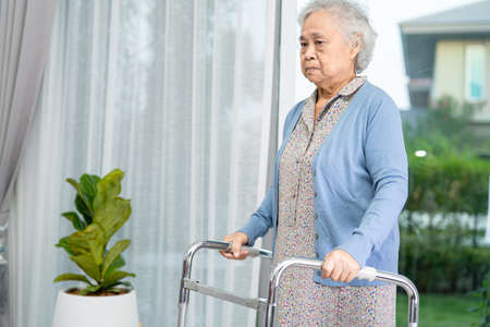 Asian senior or elderly old lady woman patient walk with walker at nursing hospital ward, healthy...