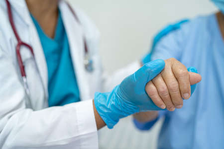 Elderly Asian senior woman wearing face mask getting virus vaccine by doctor make injection.の写真素材
