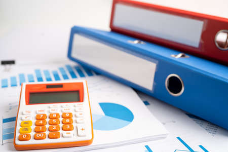 Binder data finance report business with calculator on graph analysis in office.の写真素材