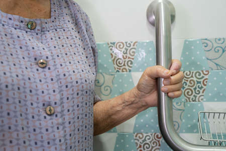 Asian senior or elderly old lady woman patient use toilet bathroom handle security in nursing...