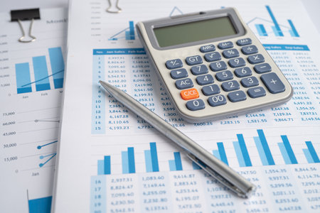 Calculator on chart and graph spreadsheet paper. Finance development, Banking Account, Statistics, Investment Analytic research data economy, Stock exchange trading, Business company concept.の写真素材