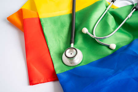 Black stethoscope on rainbow flag background, symbol of LGBT pride month  celebrate annual in June social, symbol of gay, lesbian, bisexual, transgender, human rights and peace.の写真素材