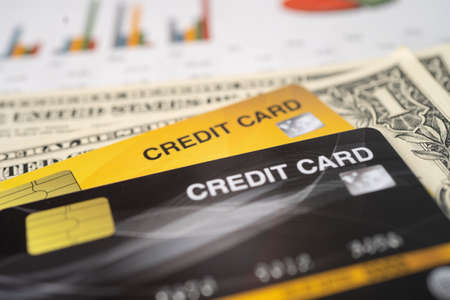 Credit card with US dollar banknote on chart and graph paper. Finance development, Banking Account, Statistics, Investment economy business.の写真素材
