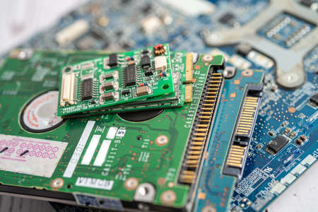 Technician repairing inside of mobile phone by soldering iron. Integrated Circuit. the concept of...