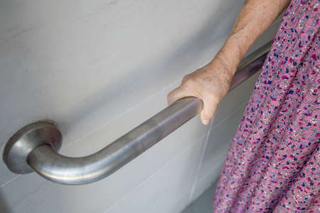 Asian senior or elderly old lady woman patient use toilet bathroom handle security in nursing...