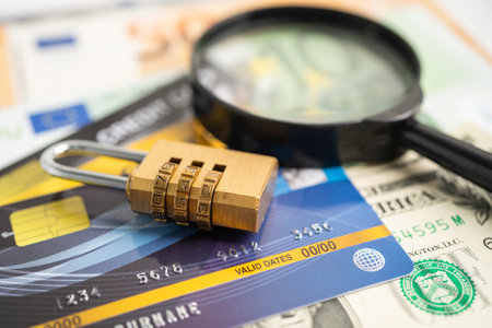 Credit card with password key lock on US dollar background.の写真素材
