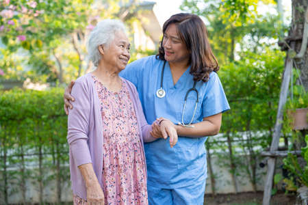 Doctor help and care Asian senior or elderly old lady woman use walker with strong health while...