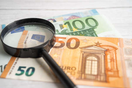 Magnifying glass with EU banknotes background, Banking Account, Investment Analytic research data...