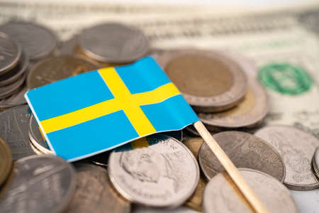 Stack of coins with Sweden flag on USA America dollar banknotes.の写真素材