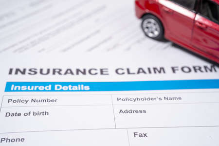 Red car on Insurance  claim accident car form, Car loan, insurance and leasing time concepts.の写真素材
