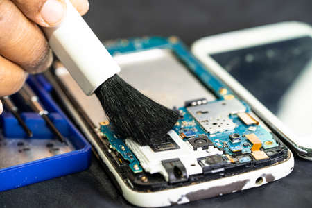 Technician use brush and air blower ball to clean dust in circuit board computer. Repair upgrade and...