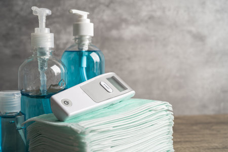 Blue alcohol sanitizer gel with digital thermometer and mask for new normal protect virus pandemic.
