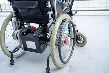 Asian senior or elderly old lady woman patient on electric wheelchair with remote control at nursing...